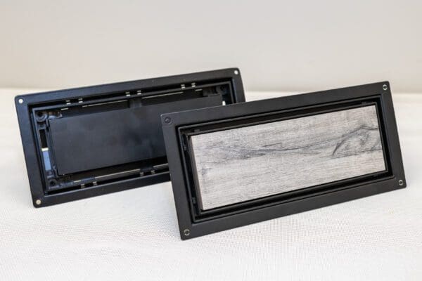 A pair of black and silver rectangular boxes.