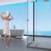 Woman in bathroom with modern shower drain.