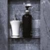Bathroom shelf with soap and dispensers.